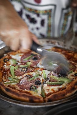 Kitche 'de pizza kesen aşçının eli.