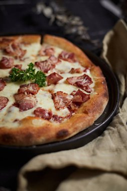 Homemade bacon and cheese pizza on the table