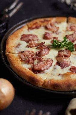 Homemade bacon and cheese pizza on the table