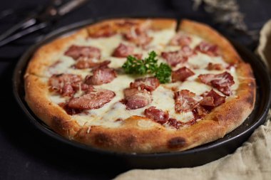 Homemade bacon and cheese pizza on the table