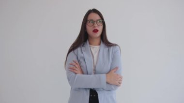 A striking young business woman rolls her eyes in displeasure and snorts and then laughs. Emotion expression concept