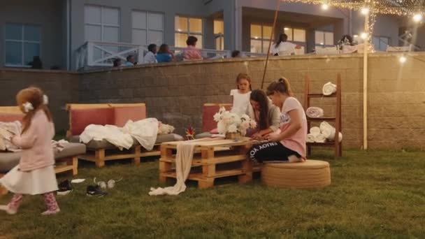 Belarus. MinskAugust 21, 2021: Party on the veranda of the cottage and a recreation area for children on the lawn near the house. Slow motion — Stockvideo