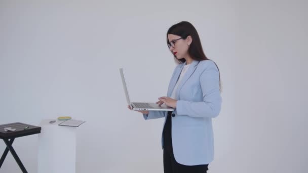Serious young business lady working on laptop and dissatisfied with slow page loading closes the lid. Woman power. Feminism. Leadership — Stock Video
