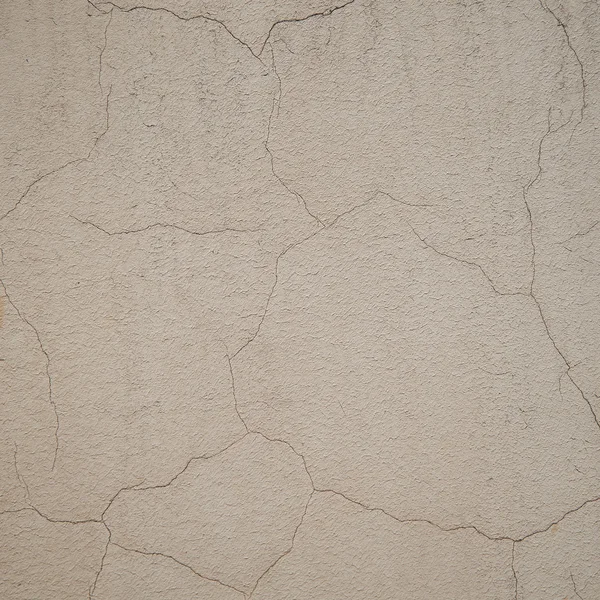 Рельефная текстура каменных стен с трещинами и шелушащимися разноцветными пятнами — стоковое фото