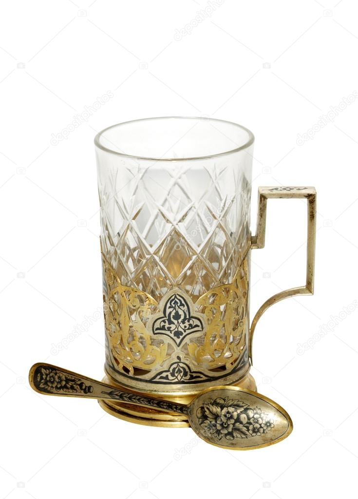 Antique gold holder with crystal glass and a gold spoon.