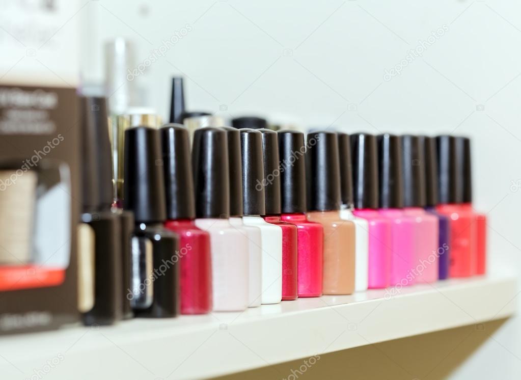 Bright nail polishes on shelf in beauty salon