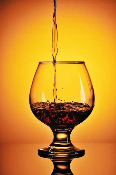 Pouring cognac in glass — Stock Photo, Image