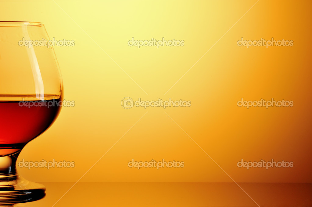Download Glass Of Cognac On Yellow Background Stock Photo C Andriikoval 17975615 PSD Mockup Templates