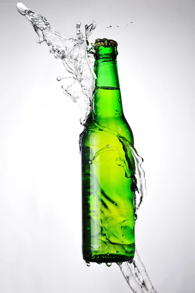 Glass bottle and water splash — Stock Photo, Image