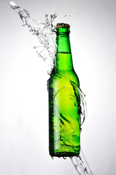 Glass bottle and water splash Stock Picture