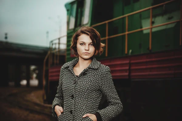 Beautiful young woman near a train — Stock Photo, Image