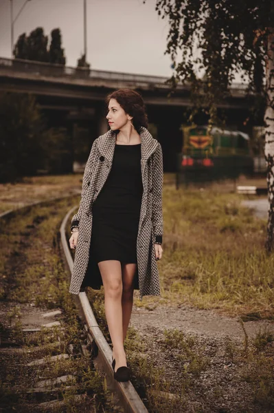 Young pretty woman walking near railway — Stock Photo, Image
