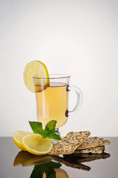 Tea with biscuits, lemon and mint — Stock Photo, Image