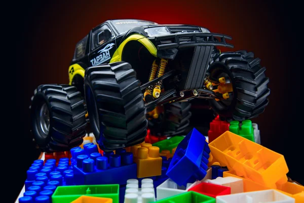 Brinquedos de plástico coloridos e carro de brinquedo — Fotografia de Stock