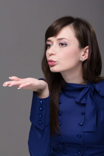 Attractive young woman blowing a kiss — Stock Photo, Image
