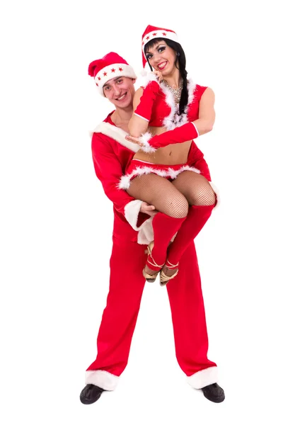 Happy young couple wearing santa claus clothes — Stock Photo, Image