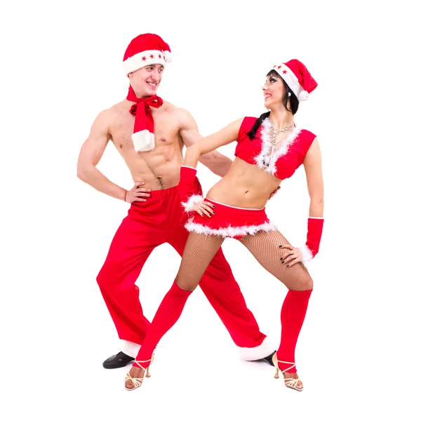 Happy young couple wearing santa claus clothes dancing — Stock Photo, Image