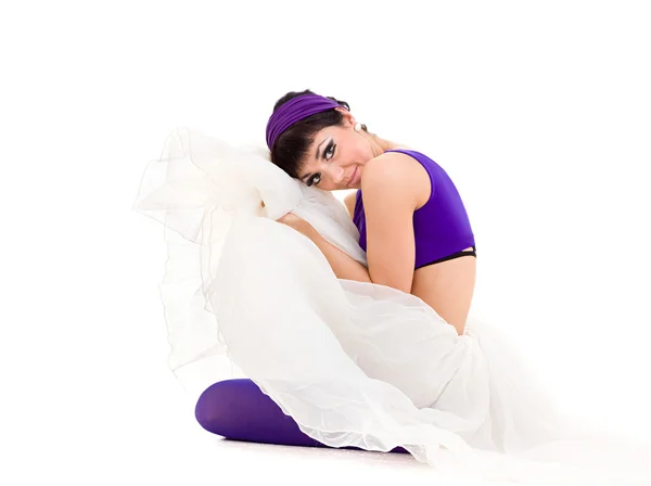 Ballerina in white tutu sitting on a white — Stock Photo, Image