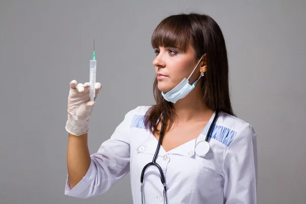 Portrait of woman doctor with a syringe — Stock Photo, Image