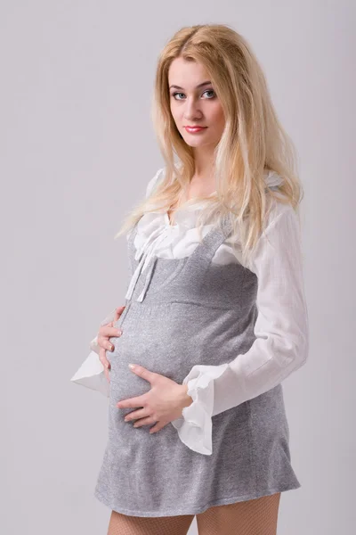 Adorable pregnant woman in modern dress — Stok fotoğraf