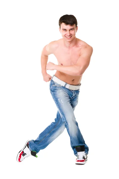 Ung vacker man i blå jeans poserar — Stockfoto