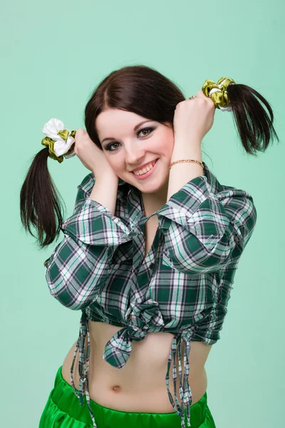 Funny cute smiling woman with pigtails on green — Stock Photo, Image