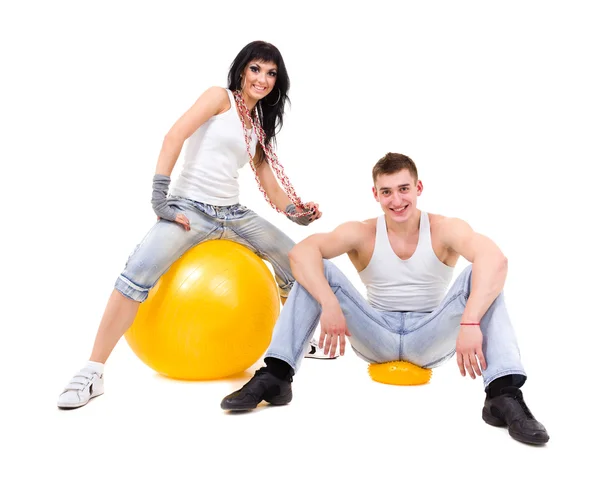 Young fitness couple wearing jeans in the studio — Stock Photo, Image