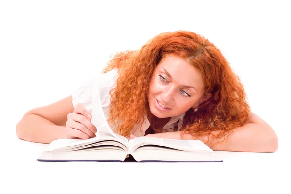 Young attractive woman with the book lying — Stock Photo, Image