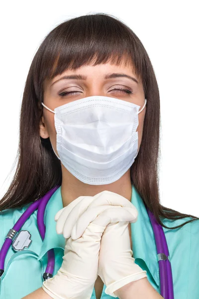 Praying female medical doctor with mask isolated — Stock Photo, Image