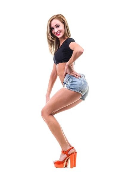 Pretty woman posing in sexy jeans shorts — Stock Photo, Image