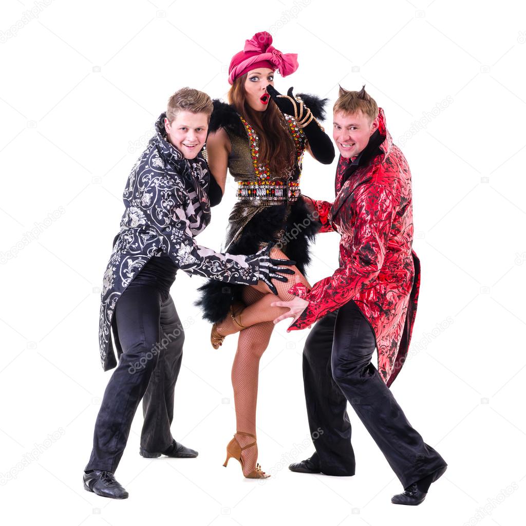 Actors dressed like a devil and demons posing on an isolated white background