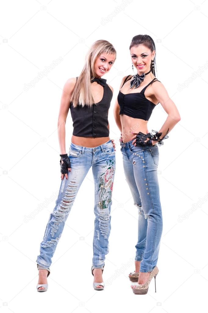 Two young sexy women in denim jeans isolated on white