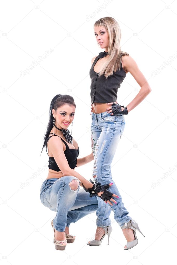 Two young sexy women in denim jeans isolated on white