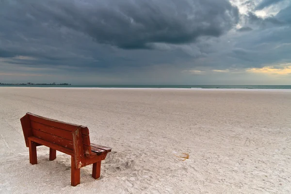 Bench on stormy white beach — Stock Photo, Image