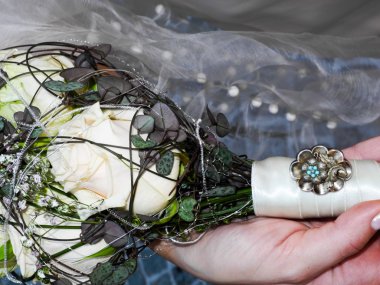 Bride holding her bridal flower bouquet in her hand clipart
