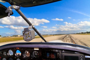 Cockpit view from small aircraft taking off from runway clipart