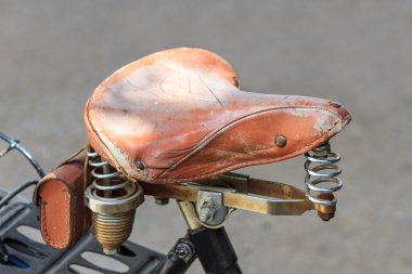 Vintage leather bike saddle with metal springs clipart