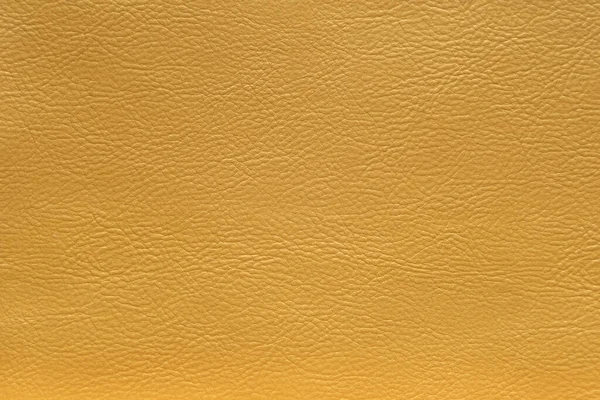 Kožená textura ve zlaté metalické barvě, pozadí. — Stock fotografie