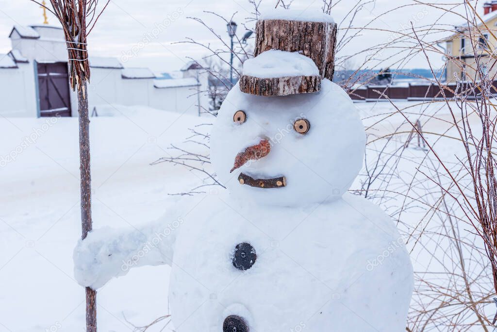 Snowman on a rural street in winter.