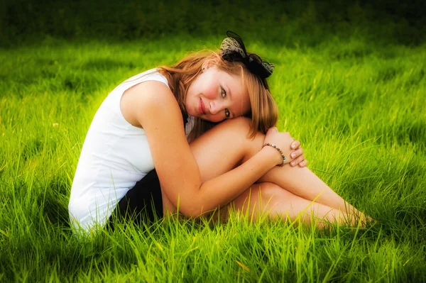 Beautiful sexy girl sitting in grass — Stock Photo, Image