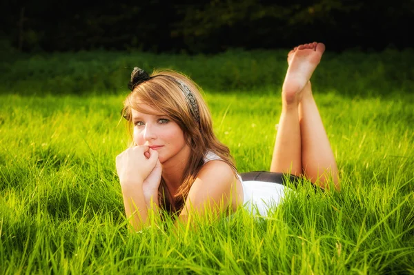 Beautiful sexy girl lying in grass — Stock Photo, Image