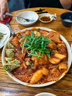 İçinde yeşil ve kırmızı biber, baharatlı sos ve pirinç makarnası var.