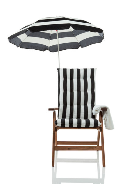 Beach chair with umbrella and a towel front view