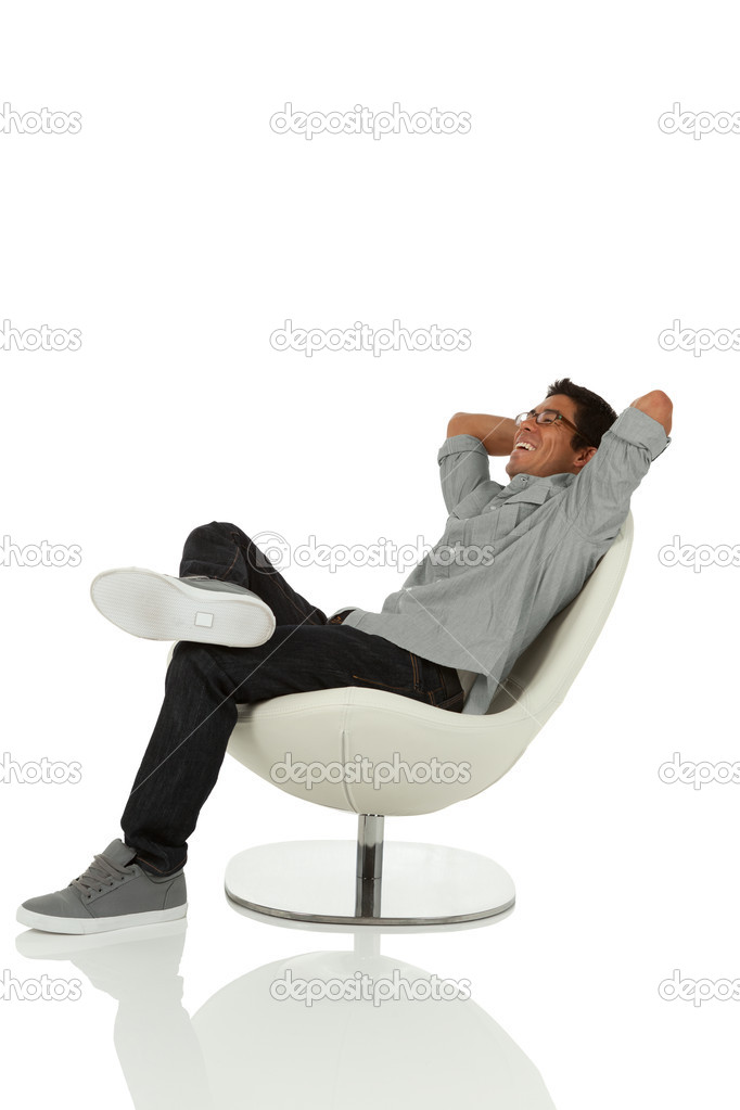 man relaxing on a modern chair looking up