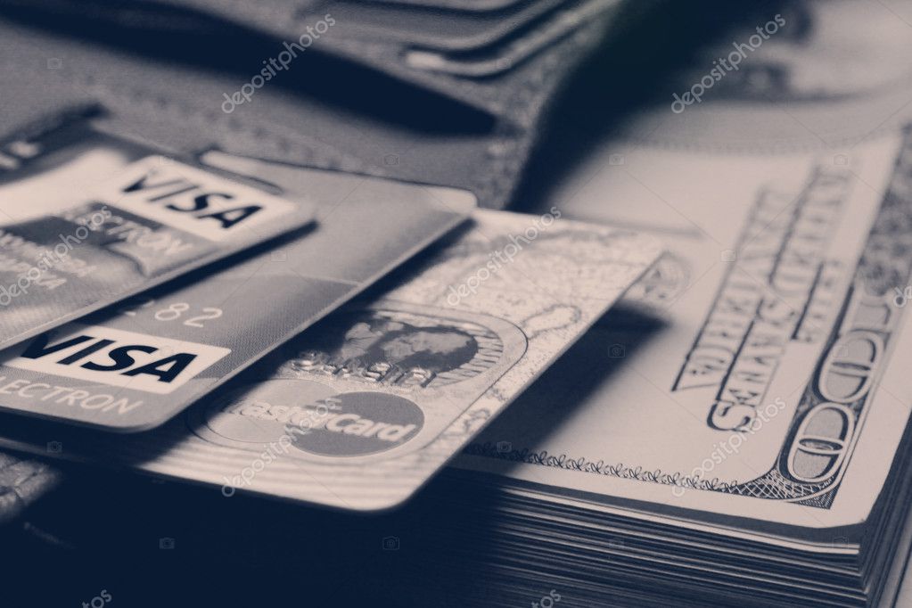 Stack of credit cards and dollars