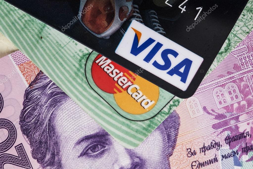 Credit cards Mastercard and Visa on a background of banknotes