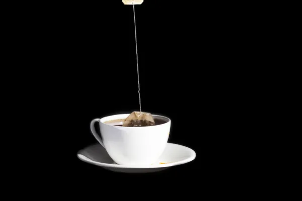 White cup on a black background — Stock Photo, Image