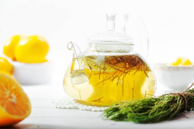 Sıcak at kuyruklu çaydanlık bitkisel çay ve taze yeşil dallar.