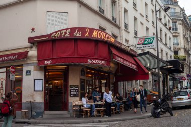 PARIS, FRANCE - JULY 08, 2022: The Two Mills is a cafe brasserie in Paris, made famous in 2001 by Jean-Pierre Jeunet's film Amlie,