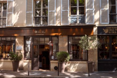 Paris, France, July 2022 - Beautiful windows of Paris. Shutters and canopies